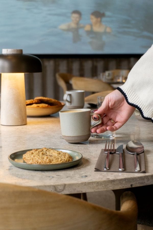 Staff member serving coffee and cake at a meeting