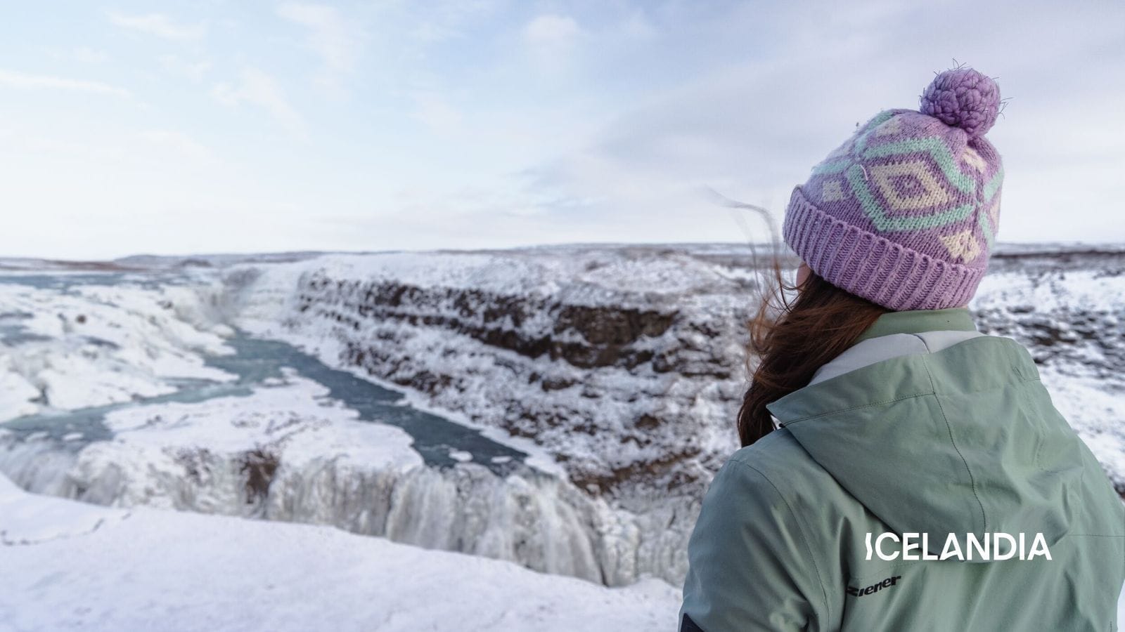person standing in front of Gullfoss in Iceland during winter