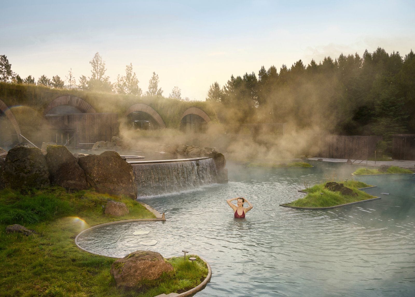 Guest relaxing in laugaras lagoon moving between the two tiers of geothermal lagoon
