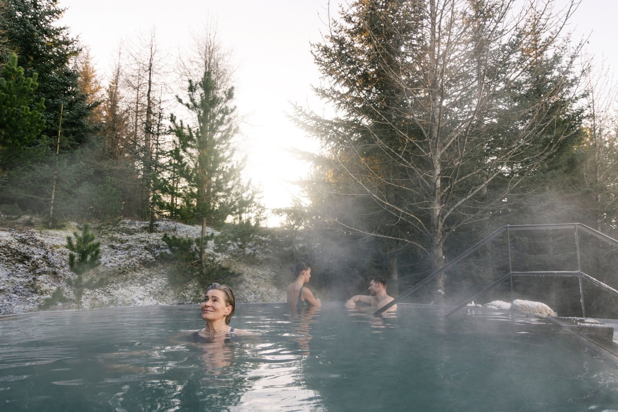 Guests in the forest pool surrounded by trees