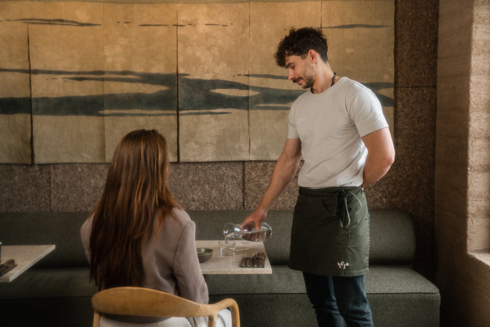 Waiter serving a guest at Ylja restaurant
