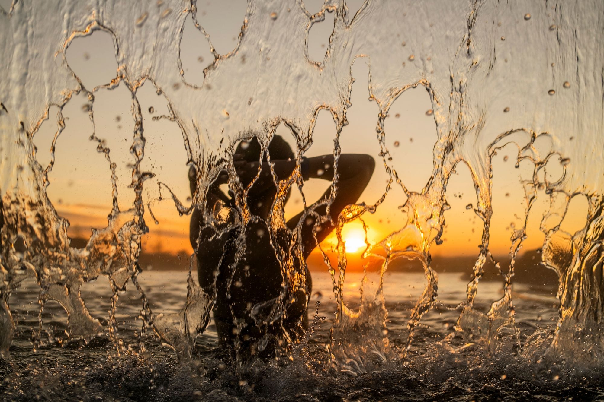 Guest under the waterfall at sunset
